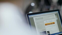 Person on laptop computer studies restaurant website and clicks on Download Today's Menu button Stock Footage