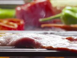 CU TD R/F from bell pepper, corn-on-the-cob, green chili pepper to strip of raw bacon on open fire grill Stock Footage