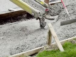MS Shot of Workmen spreading and leveling concrete being poured for sidewalk / Valparaiso, Indiana, United States Stock Footage