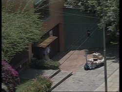 PERU: LIMA: CAPTIVES ARE SEEN CLEANING UP BACKYARD OF RESIDENCE News Clip