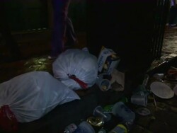 Medium Shot - Full trash bags on the street next to garbage can / New Orleans Louisiana Stock Footage