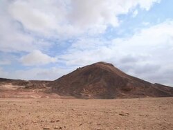 clouds over vulcanic hill in ramon crater Stock Footage