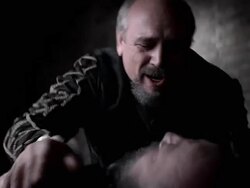 A grief-stricken priest genuflects near a deceased man. Stock Footage