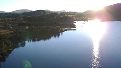 aerial view of lake and mountain in Jura Stock Footage