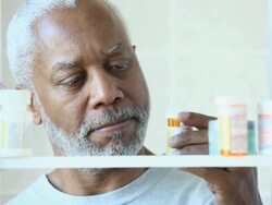 CU Senior Man Taking Prescription Bottle from Medicine Cabinet / Richmond, Virginia, USA Stock Footage