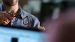 Wood shop workers assemble glasses with laptop design program Stock Footage