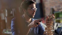 Expert craftsman chisels wooden chair frame in workshop Stock Footage