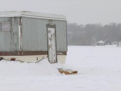 WS View of ice fishing house on frozen lake during winter / Minneapolis, Minnesota, USA Stock Footage