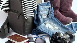 Still life of travelling concept with camera, jean, boots, handbag on white background Stock Footage