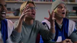 Group of young adult males watching sports on TV upset over loss Stock Footage