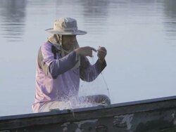 MS fisherman untangling net / Vientiane, Laos Stock Footage