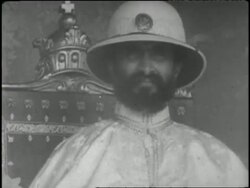 Ethiopian Emperor Haile Selassie wears a robe and helmet. News Clip