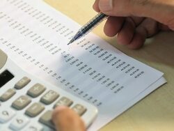 Comptroller checking financial transactions on a calculator  Stock Footage