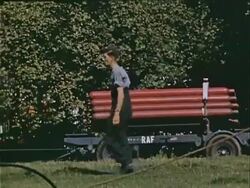 1939 Wide shot Man walking past cart stacked with Royal Air Force bombs during war preparations / London, England  Stock Footage