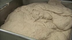 Dough fills a stainless steel pan. Stock Footage