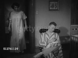 1953: NEWBORN: TWO AM: General Electric square clock face displaying time 2:50, 20 to 3. 'Grace Hobbs' joining husband 'Walter' in nursery, taking over feeding newborn infant.  [SOT Dr. Spock talking about not being slace to time tables]... Instructional Video