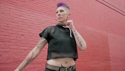 Cool young woman practicing martial arts kick in urban alley Stock Footage