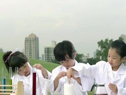 MS SLO MO ZI Two girls and one boy working in science project / Seoul, South Korea Stock Footage