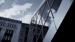 Monochrome architectural detail with modern glass windows contrasted with early 20th century stone building. Stock Footage