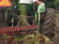 MS SLO MO R/F Shot of Young farmer looking behind as he plows field at organic farm with blades and soil / Chatham, Michigan, United States Stock Footage