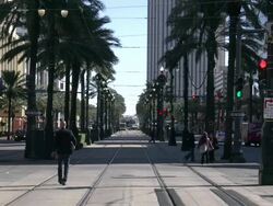 Morning walkers and traffic on Canal Street in New Orleans Stock Footage
