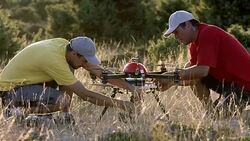 SLO MO Two operators preparing a drone before takeoff Stock Footage