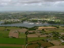 WS AERIAL View over harbor and farm field / Brittany, France Stock Footage