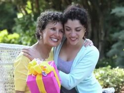 PAN hispanic daughter greeting mother with present, Richmond, Virginia, United States Stock Footage