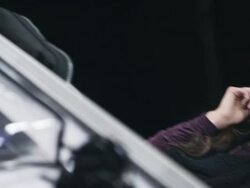 MS TU PAN Female fashion model backstage at fashion show looking at herself in mirror before turning to walk away Stock Footage