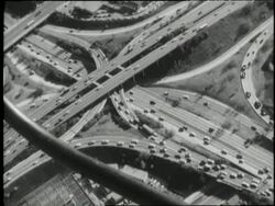 Traffic drives on a highway with many ramps and overpasses. News Clip