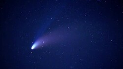 A comet leaves a trail as it speeds across a star filled night sky. Stock Footage
