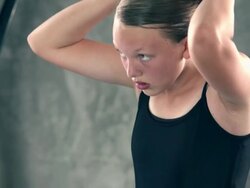 MS TD TU young ballerina girl sitting on floor pinning  red rose into her hair in preparation for  ballet performance / Rancho Mirage, California, United States  Stock Footage