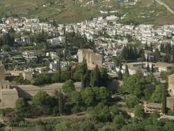 aerial view of the Alhambra of Granada, starting approximately at the Palace of Charles V, then covering the entire complex to the  Alcazaba, ending on the Albaicin district of Granada Stock Footage