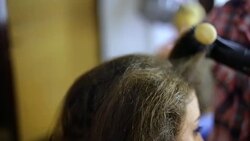 Drying long brown hair with hair dryer and round brush Stock Footage
