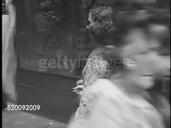 1947: WALK IN THE PARK: Woman wearing dress suit & heels walking short spaniel dog w/ docked tail on sidewalk. NEW STYLES: VS Two women walking on sidewalk wearing full bias cut skirts greeting others, VS Two women in fuller cut coats, one cape style. Instructional Video