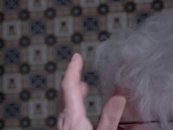 Elderly woman arranging her hair Stock Footage