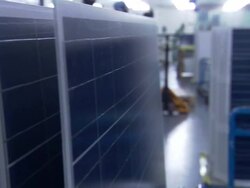 Medium pan,left rack,focus zoom,in , Factory workers assemble solar panel parts. / California Stock Footage