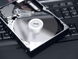Spinning Hard Drive On Top Of Illuminated Keyboard Close Stock Footage
