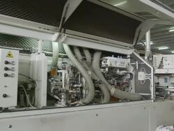 TS machine in furniture factory with operator inputting commands at end of clip Stock Footage