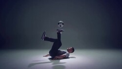young male soccer freestyler juggling a ball on his brines Stock Footage