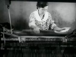 B/W 1934 middle-aged woman using loom in WPA weaving project / documentary Stock Footage
