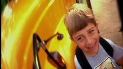 A boy's smiling face reflects in a school bus mirror. Stock Footage