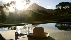 Swimming pool looking out to scenic mountain sunset Stock Footage