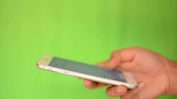 Smartphone touchscreen on green screen Stock Footage