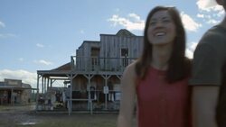 Group of friends walk through Texas ghost town arm in arm Stock Footage