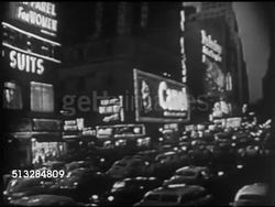 1952: NEW YORK CITY: TIMES SQUARE: NIGHT: HA WS Times Square cityscape (VO George Skinner), neon lights, taxi cabs, REVERSE PAN Area w/ traffic, buildings w/ advertising signs, 'Camel' ad, Bond clothing w/ clock in 'o', WS (Poor focus) Crowd of people Instructional Video