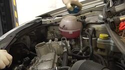 A mechanic servicing the engine of a Volkswagen car News Clip