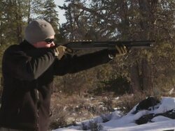 CU SLO MO Shot of man shoots shotgun in winter wood landscape / Bend, Oregon, United States  Stock Footage