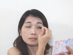 Young woman applying makeup Stock Footage