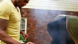 MS ZO TU Man barbecuing for friends during backyard party Stock Footage